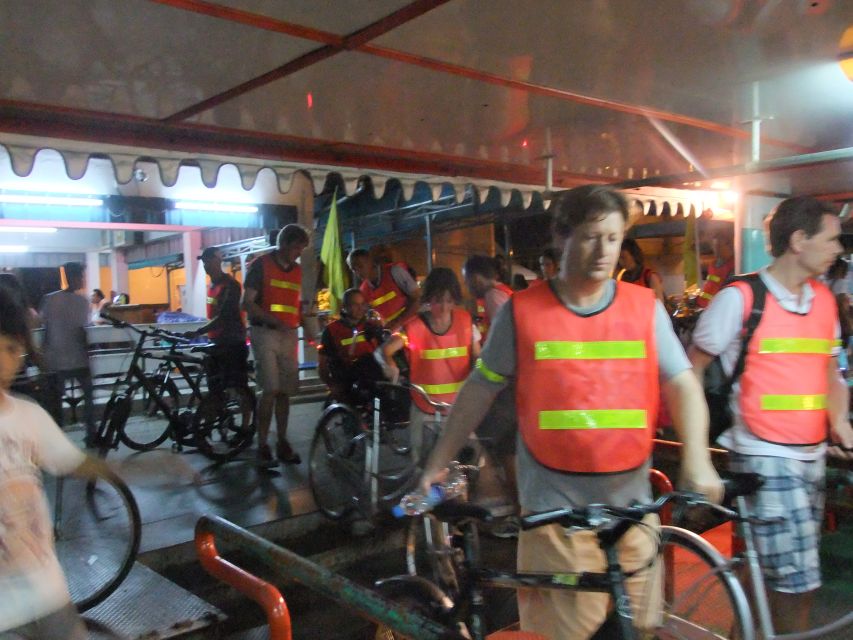 Bangkok by Night Cycling Tour with Street-food Meal - Crossing the river by pedestrian ferry