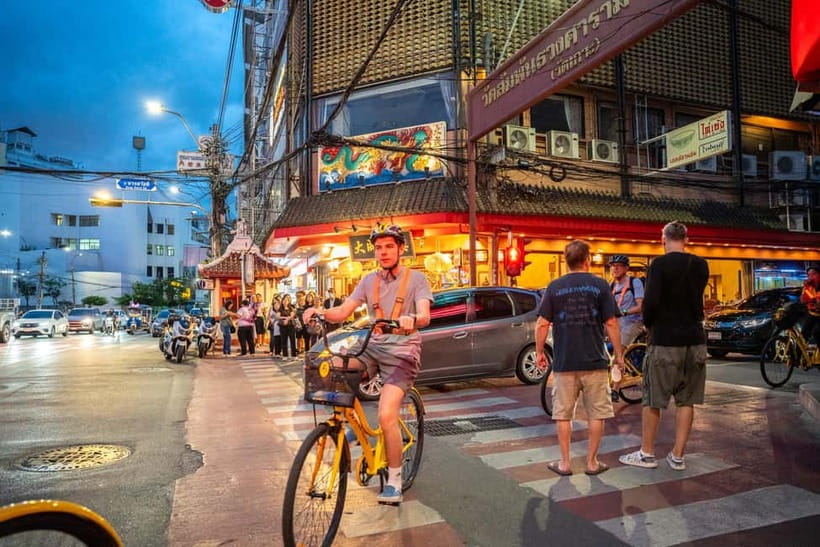 Bangkok by Night Cycling Tour with Street-food Meal - Chinatown under lanterns and shop signs