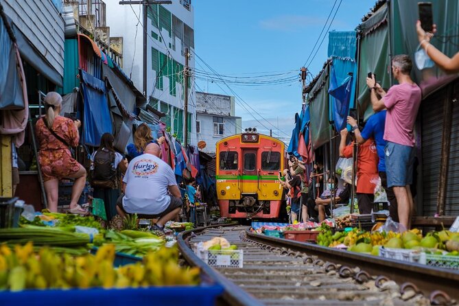 Damnoen Saduak Floating Market and Maeklong Railway Market Tour - Damnoen Saduak: canals, boats, and higher prices