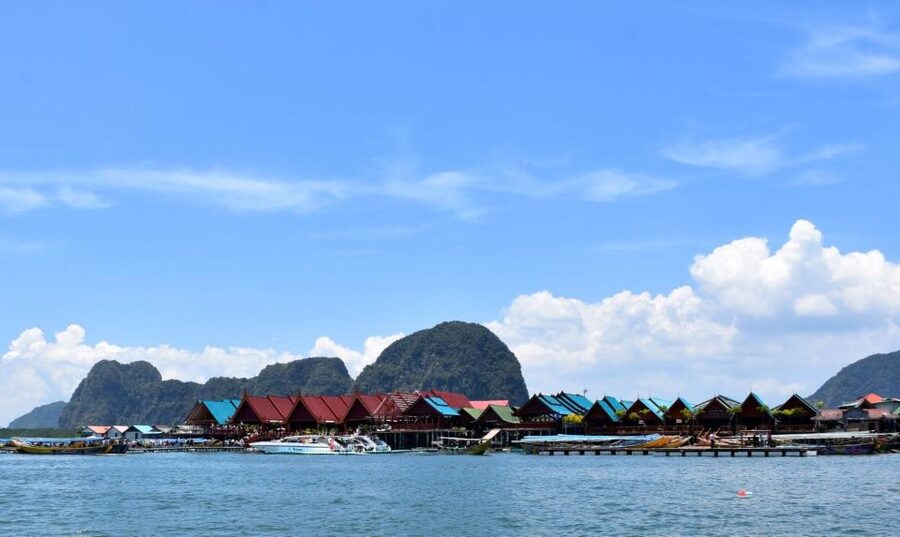 James Bond Island: Sightseeing Tour by Longtail Boat & Kayak - Riding a longtail boat across the bay