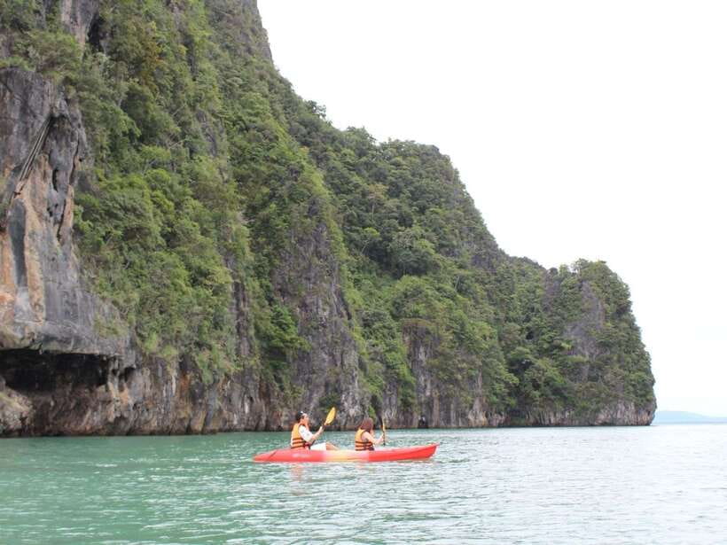 Koh Lanta: Sea Cave Kayaking and Talabeng Island Tour - Riding a traditional longtail boat toward the islands